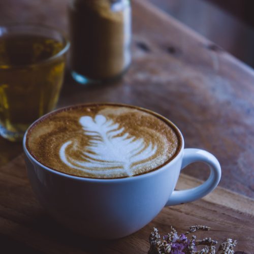 coffee hot drink cappucino latte art on wood vintage table , coffee time on wood background cafe